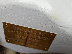 The brass plate under the belly of the horse.